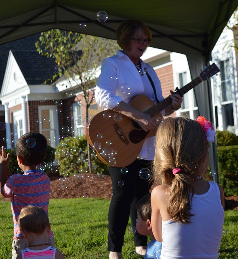 Nini Bambini - First New Hampshire milk depot celebration -  Guitarist playing for happy kids