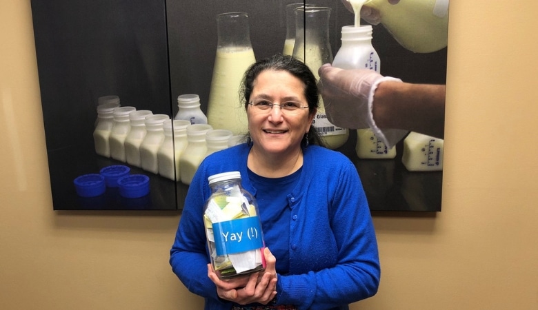 Caring staff member with milestone jar