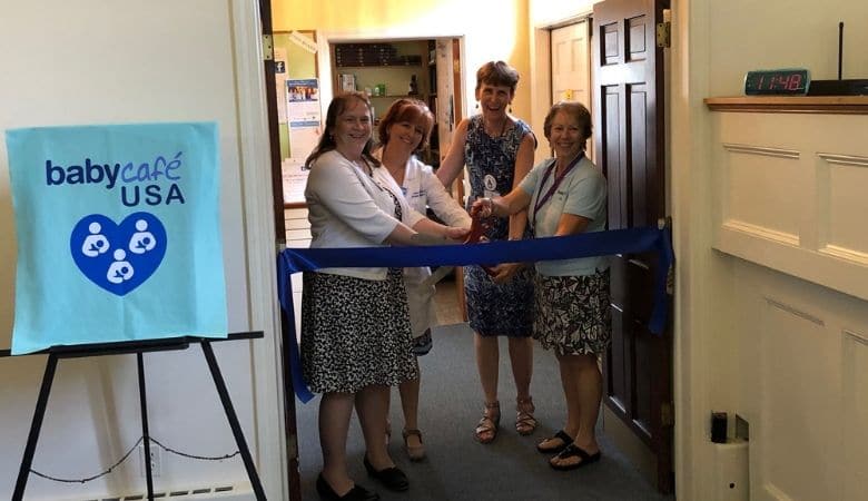 Community partners cutting ribbon at milk depot opening