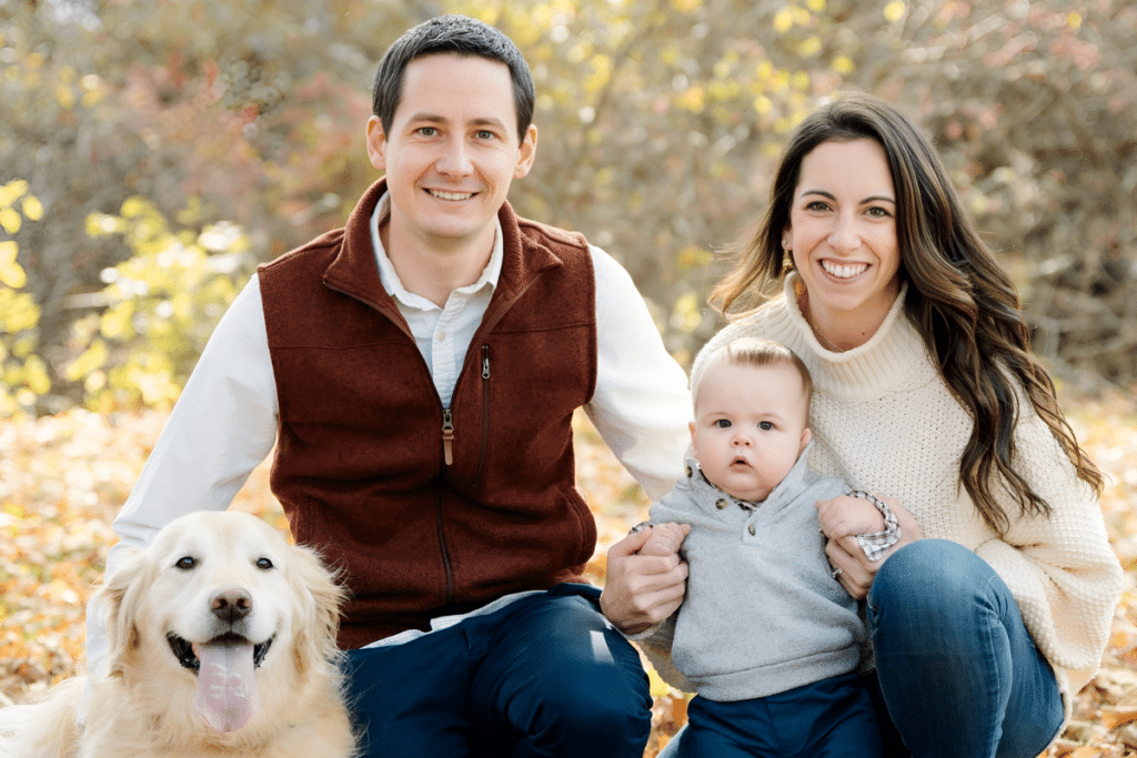 Smiling family among the fall foliage